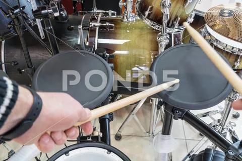 Drummer knocks on electric drum Stock Photos