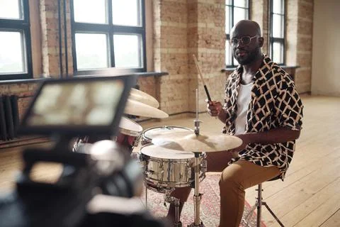 Drummer performing on drums on camera Stock Photos