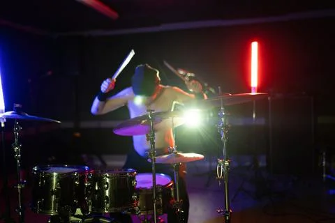 Drummer performing live on stage with drum kit Stock Photos