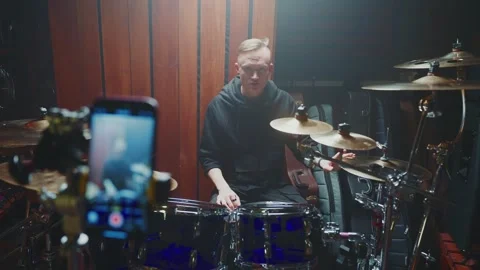 Drummer performs live in studio setting with recording equipment present Stock Footage 307125003