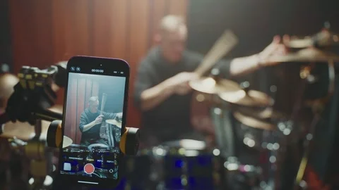 Drummer performs live in studio while being recorded on smartphone Видео 307124316