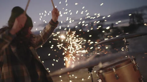 Drummer performs vibrant music at sunset using stunning fireworks display Stock Footage 320019447