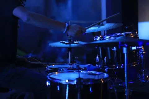 Drummer playing cymbals under blue stage light Stock-Fotos