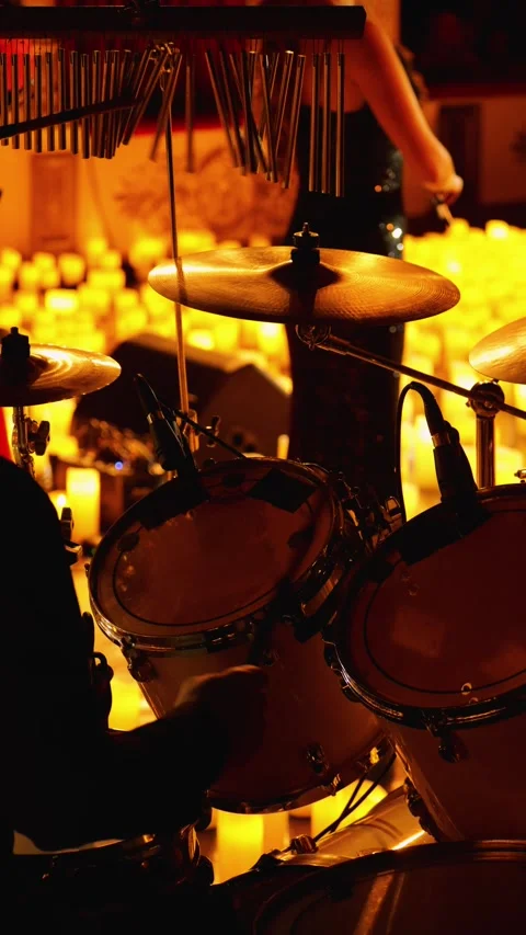 A drummer playing a drum kit on a dimly lit stage Stock Footage 286886750