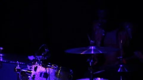Drummer playing drum kit on stage under blue lights Stock-Footage 98743412