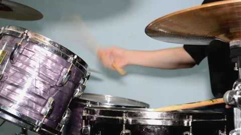 Drummer playing on drum set with puprple drum and cymbals, playing with sticks Stock Footage 106301429