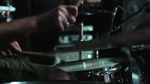 Drummer playing on a drum set on a stage with concert lighting during the show Stock Footage 249356827