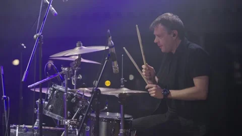 Drummer playing drums during rock concert on stage with spotlights. Live concert Stock-Footage 243935319