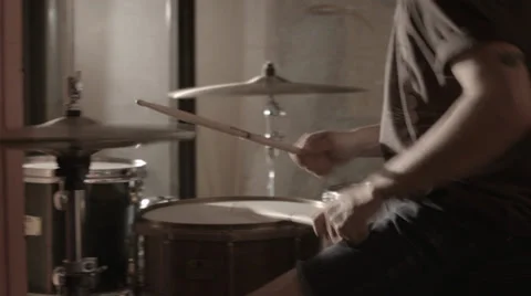 Drummer playing drums in a hallway with camera sweeping past Stock Footage 38035525