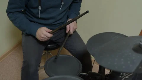 Drummer playing electronic drums with drumsticks in home studio Stock Footage 293036278