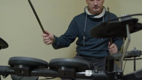 Drummer playing electronic drums with drumsticks in home studio Stock Footage 301274741