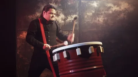 Drummer playing handmade drum Stock Footage 91855339