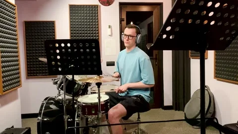 Drummer playing in a recording studio Stock Footage 313994163