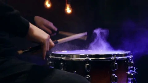 Drummer playing with sticks on a snare drum with smoke with beautiful lighting. Stock Footage 146943190