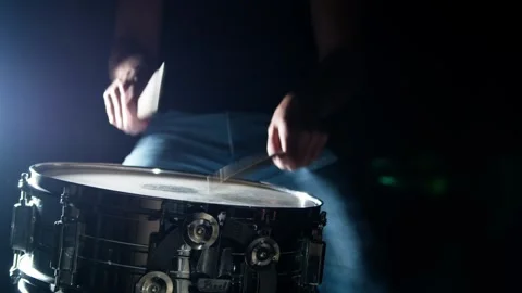 Drummer plays drum rudments, practise rolls, on snare drum, dark background. Stock Footage 345590810