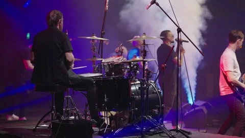 Drummer plays drums during show. Musicians play on stage. Slow motion Stock Footage 243766494
