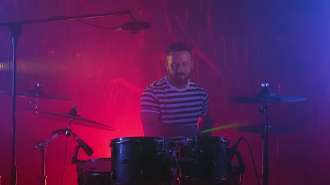 The drummer plays the drums in the recording studio. Music band having rehearsal Stock Footage 255153634