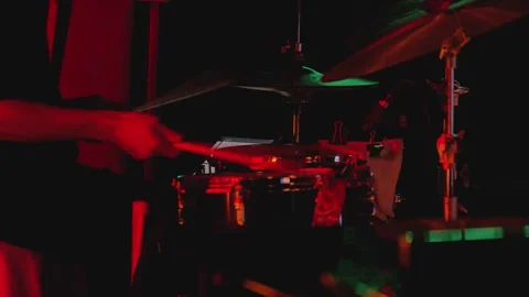 A drummer plays the kit. His hands move as he plays the snare drum Stock Footage 344873128