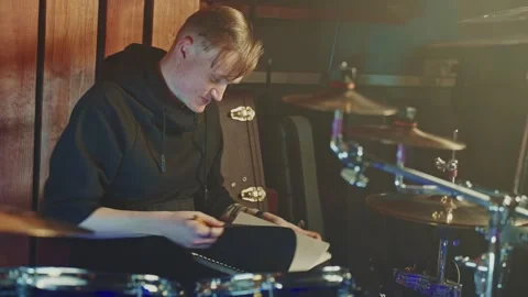 Drummer prepares for performance in dimly lit venue before showtime Stock Footage 305847703