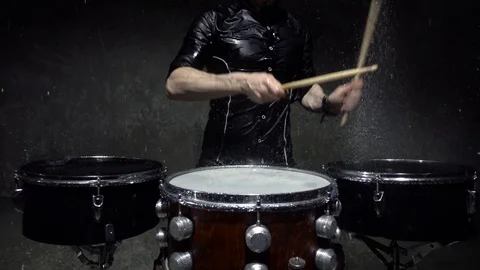 Drummer in the rain close up slow motion Stock Footage 98377064