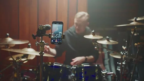 Drummer records performance while capturing creativity in studio setting Stock Footage 307125131