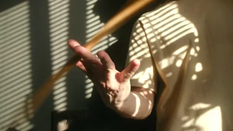 Drummer spinning drumstick with artistic light and shadow 스톡 동영상 337831228