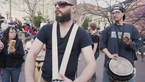 Drummers performing during Drum circle in downtown Asheville, NC Stock Footage 103433679