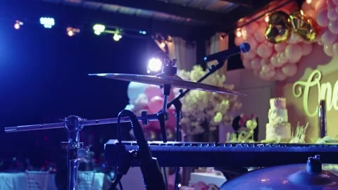 Drumset at a party with colorful lights behind Stock Footage
