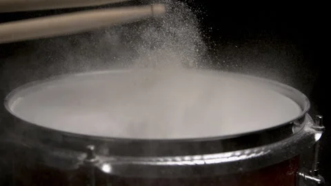 Drumstick Hitting Drum with Water on It Splattering Off in Slow Motion Stock Footage 270404537