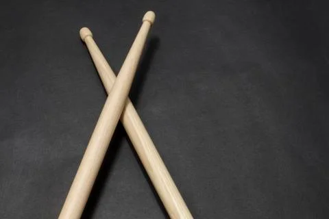 Drumsticks on a black background. Stock Photos