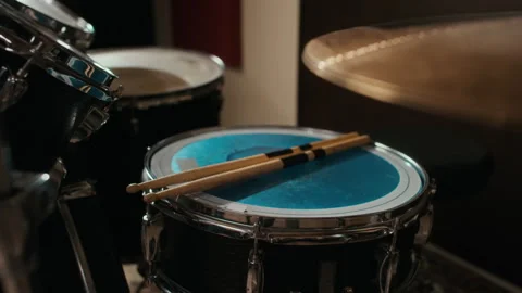 Drumsticks Resting on Snare Drum during Band Rehearsal in Studio Stock Footage 336376798