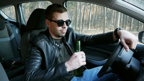 Drunk driver drinking beer while driving, traffic offense Stock Footage 106683852