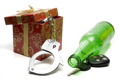 Drunk Driving Concept Car keys, beer bottle and a present of handcuffs. Co... Stock Photos