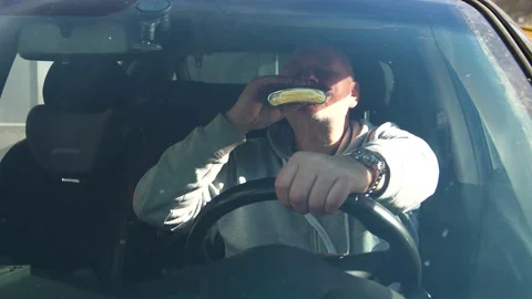 Drunk driving. The driver drinks strong alcohol while driving. Stock Footage 320357259