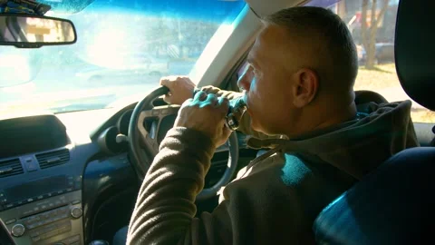 Drunk driving. The driver drinks whiskey while driving. Stock Footage 320356882
