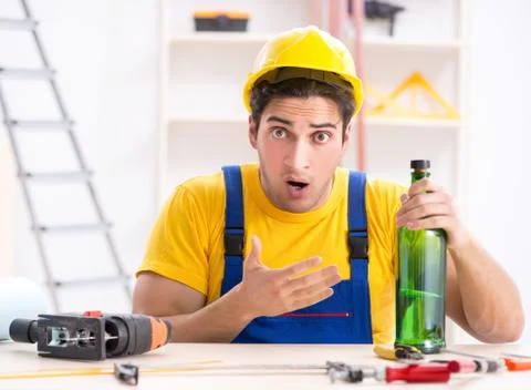 Drunk engineer working in the workshop Stock Photos
