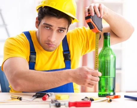 Drunk engineer working in the workshop Stock Photos