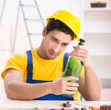 Drunk engineer working in the workshop Stock Photos