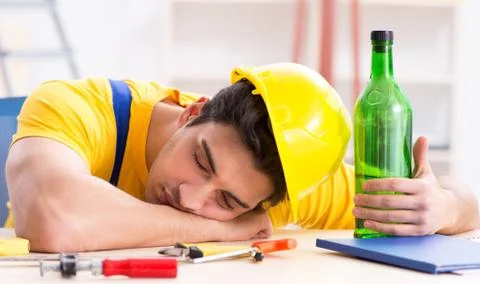 Drunk engineer working in the workshop Stock Photos