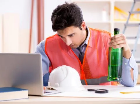 Drunk engineer working in the workshop Stock Photos
