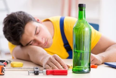 Drunk engineer working in the workshop Stock Photos