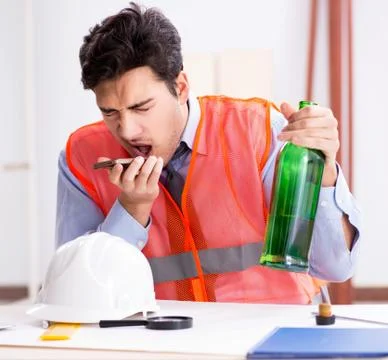 Drunk engineer working in the workshop Stock Photos