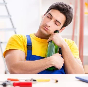Drunk engineer working in the workshop Stock Photos