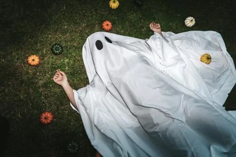 Drunk ghost laying on the floor after halloween party Stock Photos