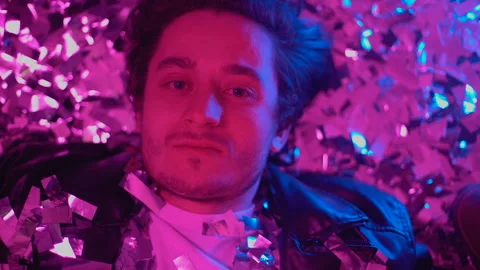 Drunk guy crying on floor at party, empty eyes staring at camera, alcoholism Stock Footage 105140161