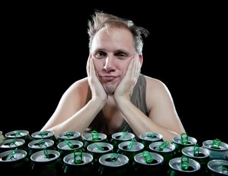The drunk man and is a lot of empty beer cans Stock Photos