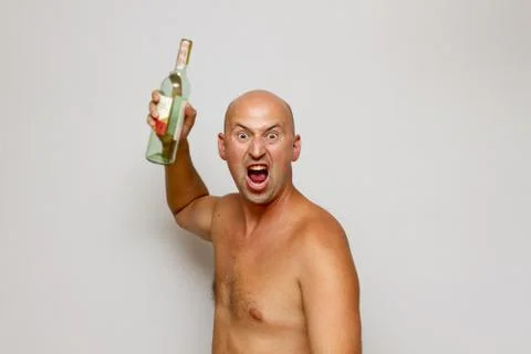 A drunk man blows a bottle Stock Photos