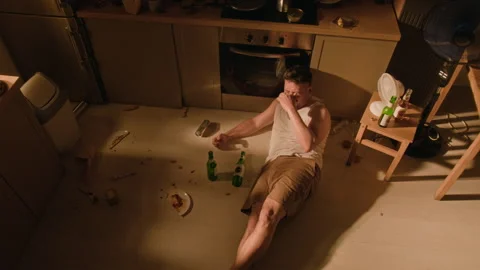 Drunk Man Drinking Beer on Floor Suffering from Alcohol Addiction Stock Footage 344853442