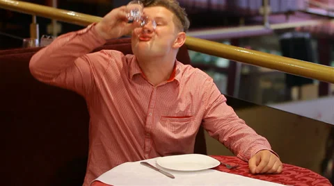 Drunk man drinking wine. falls on the table. Stock Footage 28782519