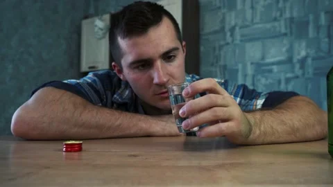 Drunk man drinks another glass of vodka Stock Footage 154953789